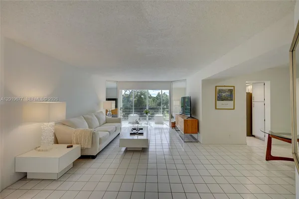 a bedroom with furniture and large windows