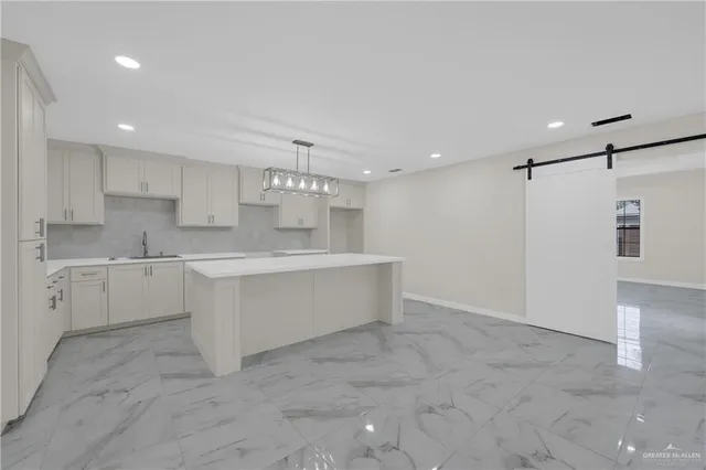 a large white kitchen with a sink