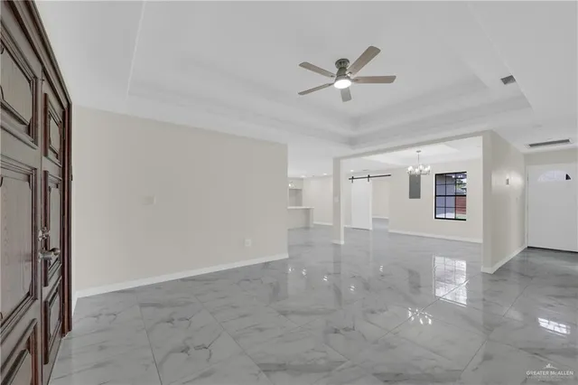 a view of a livingroom with a ceiling fan and window