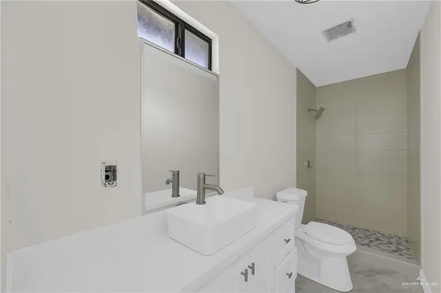 a bathroom with a sink toilet and a mirror