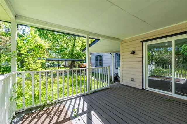 a view of a balcony with wooden floor