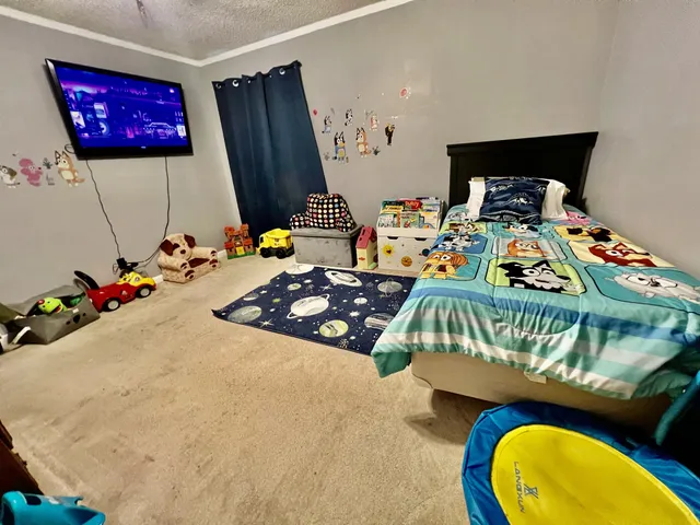 a bedroom with a bed and a window