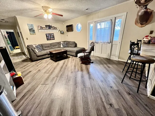 a view of a livingroom with workspace and a window