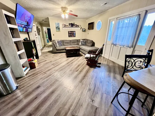 a bedroom with furniture and a flat screen tv