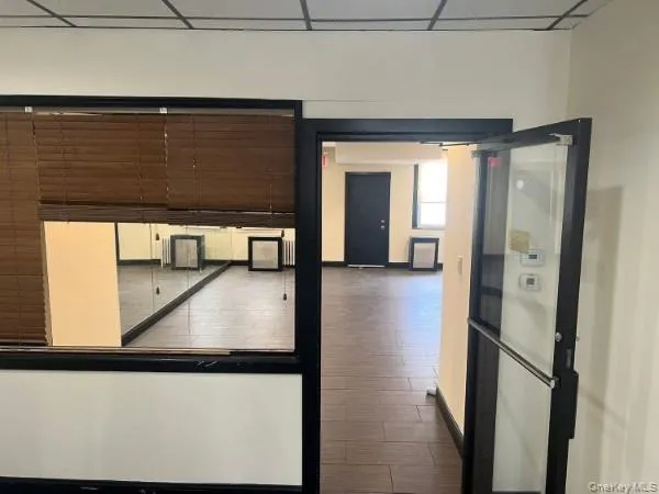 a view of a hallway with wooden floor
