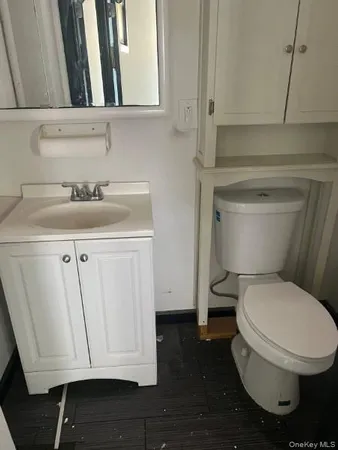 a bathroom with a toilet a sink and a mirror