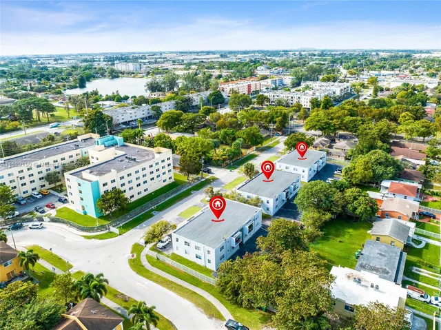 an aerial view of residential houses with outdoor space and swimming pool