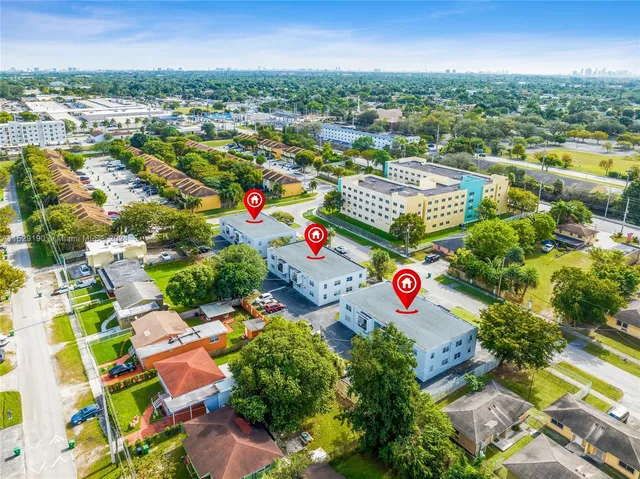an aerial view of residential houses with outdoor space