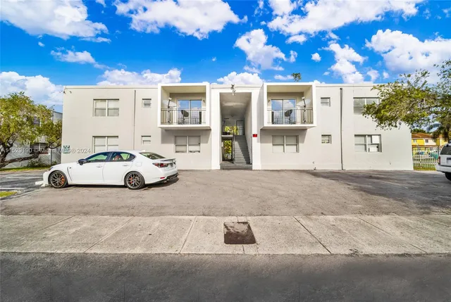 a view of a white house with a outdoor space