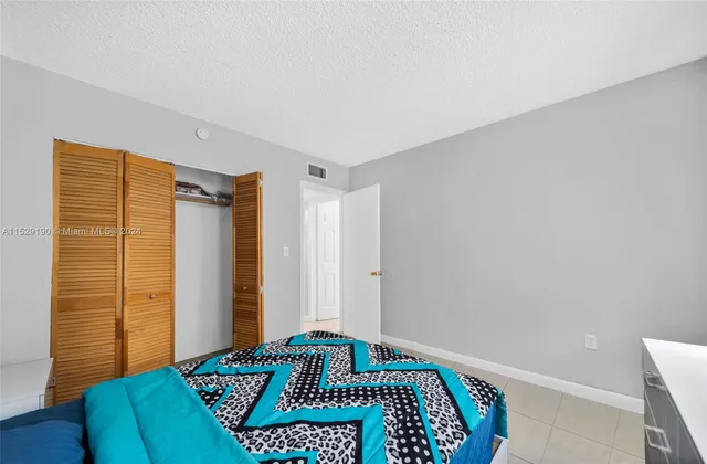 a bedroom with a bed and a rug