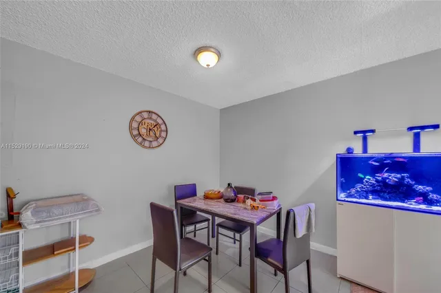 a view of a dining room with furniture and a chandelier
