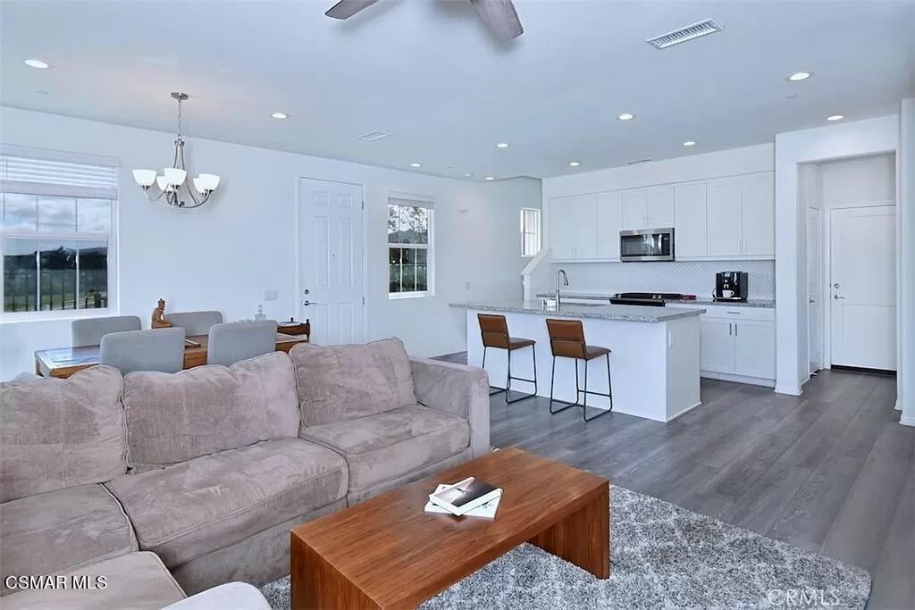 207 Morro Way, Unit 3 Simi Valley, CA 93065 - Photo 5 of 31 a living room with furniture kitchen and a chandelier