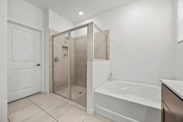 a bathroom with a shower and a bath tub