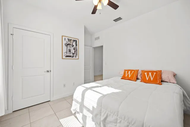 a bedroom with a bed and a painting on the wall