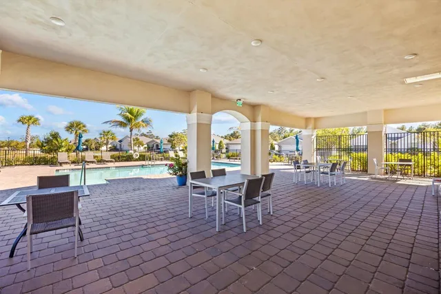 a living room with couches and a dining table with garden view