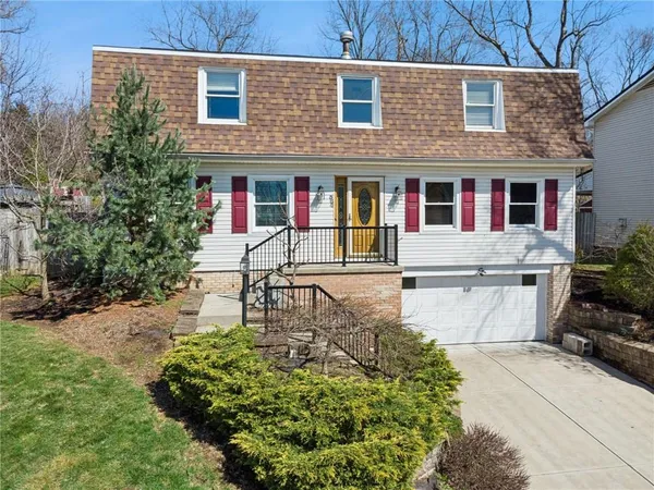 a front view of a house with garden