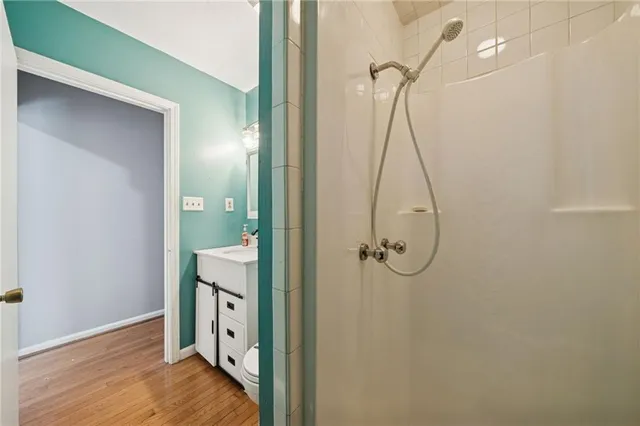 a bathroom with a granite countertop shower a mirror and a sink