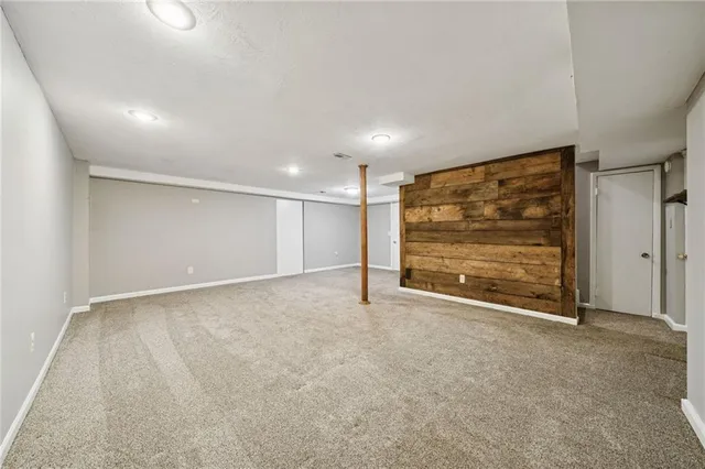 a view of an empty room with painting on the wall