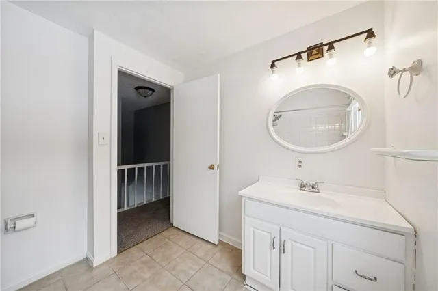 a en suite bathroom with a sink a mirror and a shower
