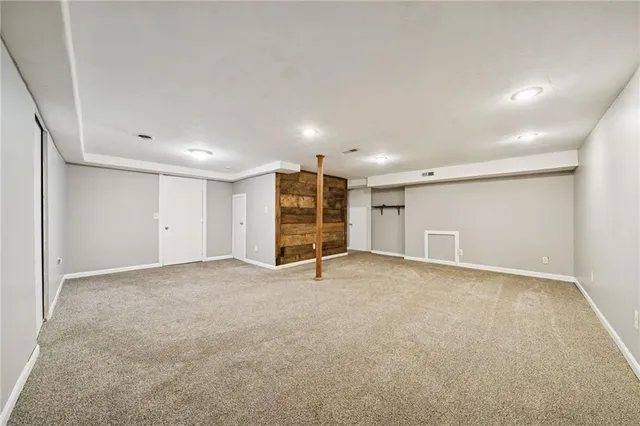 a view of an empty room with wooden shelves