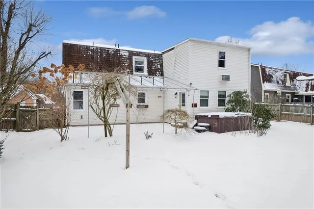 a view of multiple house with large trees
