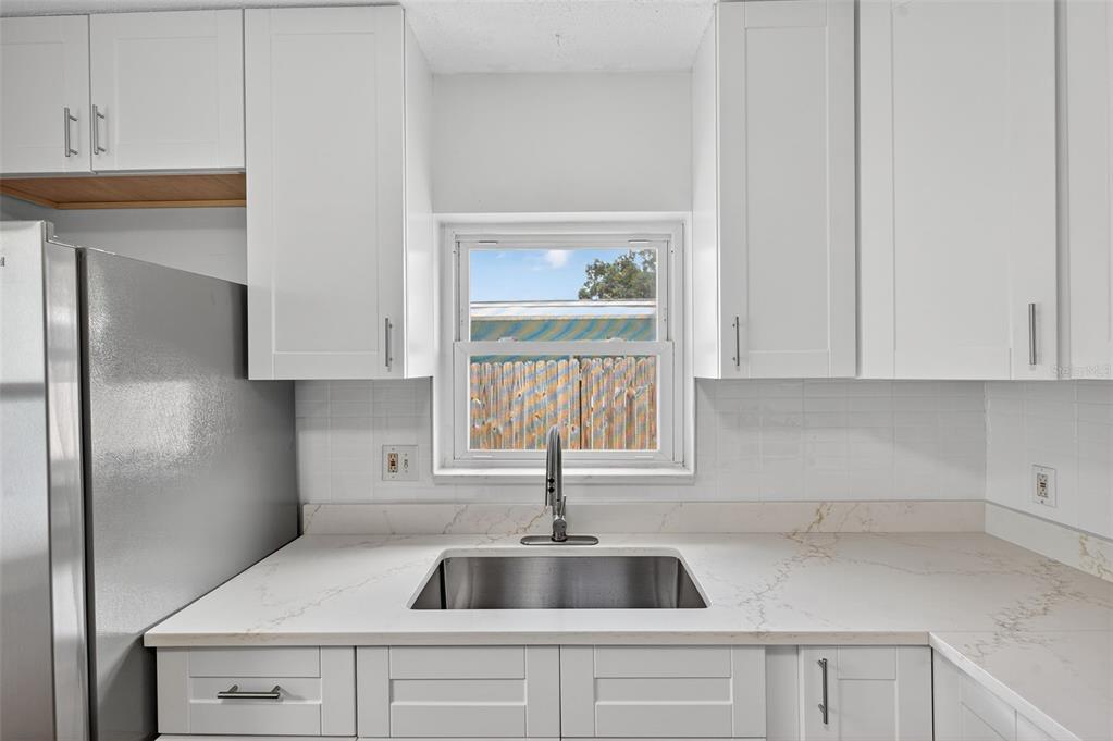12432 136th Lane Largo, FL 33774 - Photo 19 of 64 a kitchen with a sink and cabinets