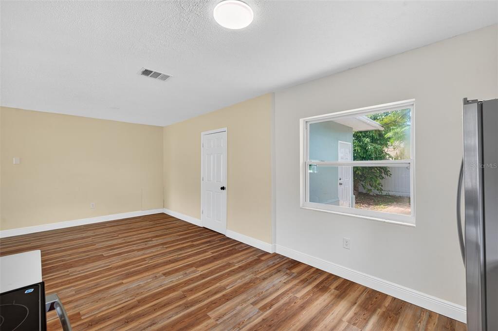 12432 136th Lane Largo, FL 33774 - Photo 20 of 64 a view of an empty room with wooden floor and a window