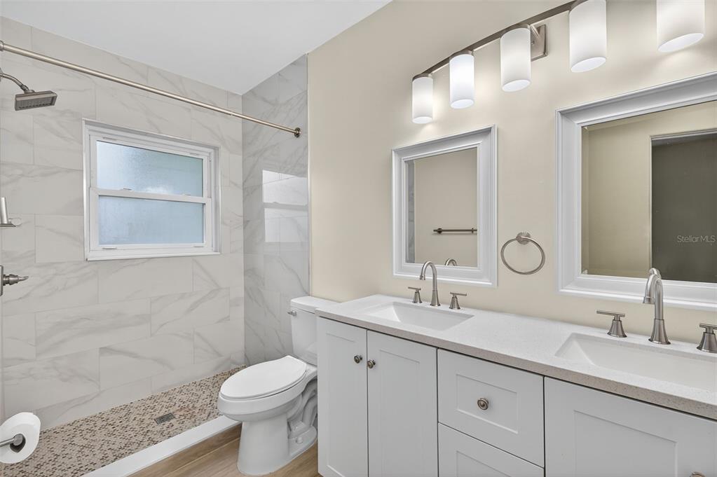 12432 136th Lane Largo, FL 33774 - Photo 29 of 64 a bathroom with a sink a toilet and shower