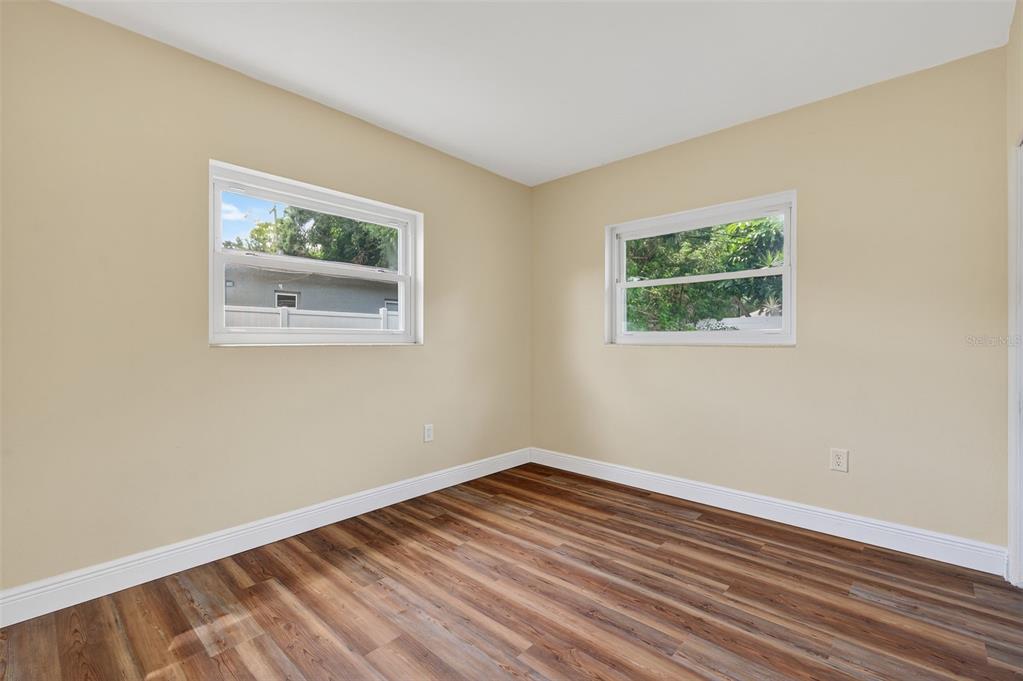12432 136th Lane Largo, FL 33774 - Photo 31 of 64 a view of an empty room with wooden floor and a window