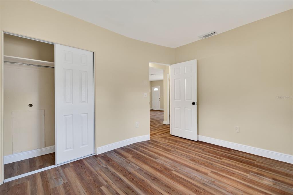 12432 136th Lane Largo, FL 33774 - Photo 33 of 64 a view of an empty room with wooden floor and closet