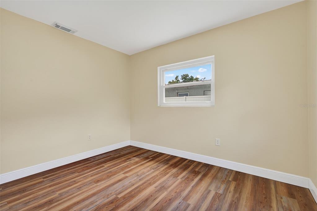 12432 136th Lane Largo, FL 33774 - Photo 34 of 64 a view of a room with wooden floor and wall painting
