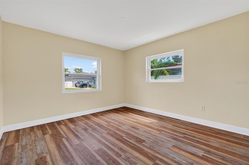 12432 136th Lane Largo, FL 33774 - Photo 35 of 64 a view of an empty room with wooden floor and a window