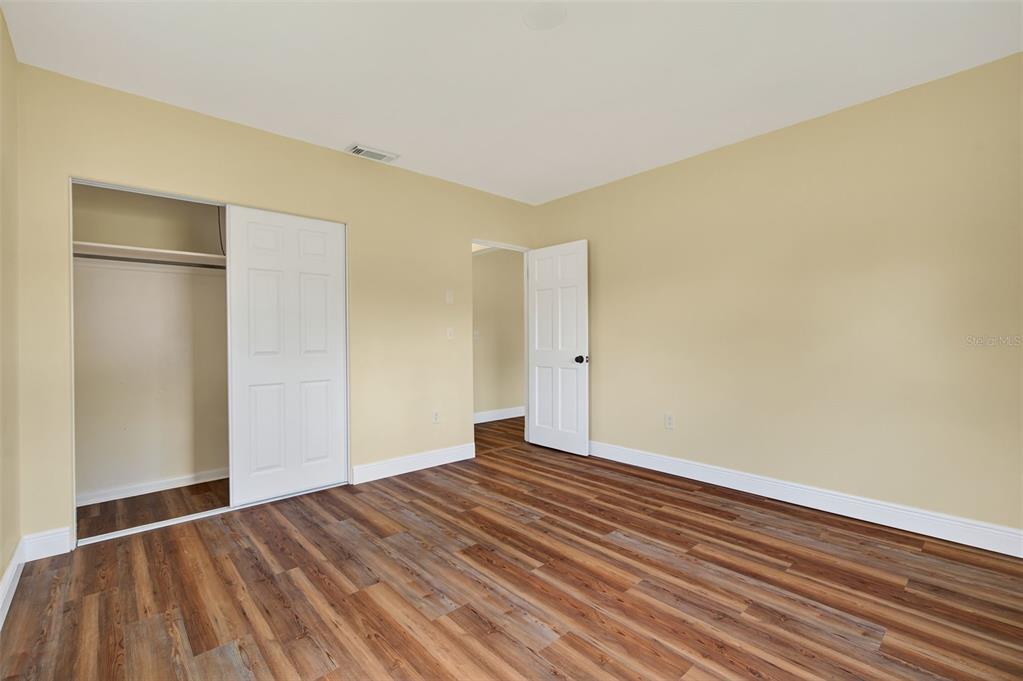 12432 136th Lane Largo, FL 33774 - Photo 37 of 64 a view of an empty room with wooden floor and a window
