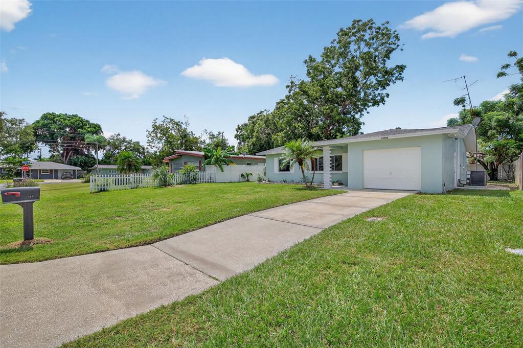 12432 136th Lane Largo, FL 33774 - Photo 5 of 64 a view of a house with a big yard plants and large trees