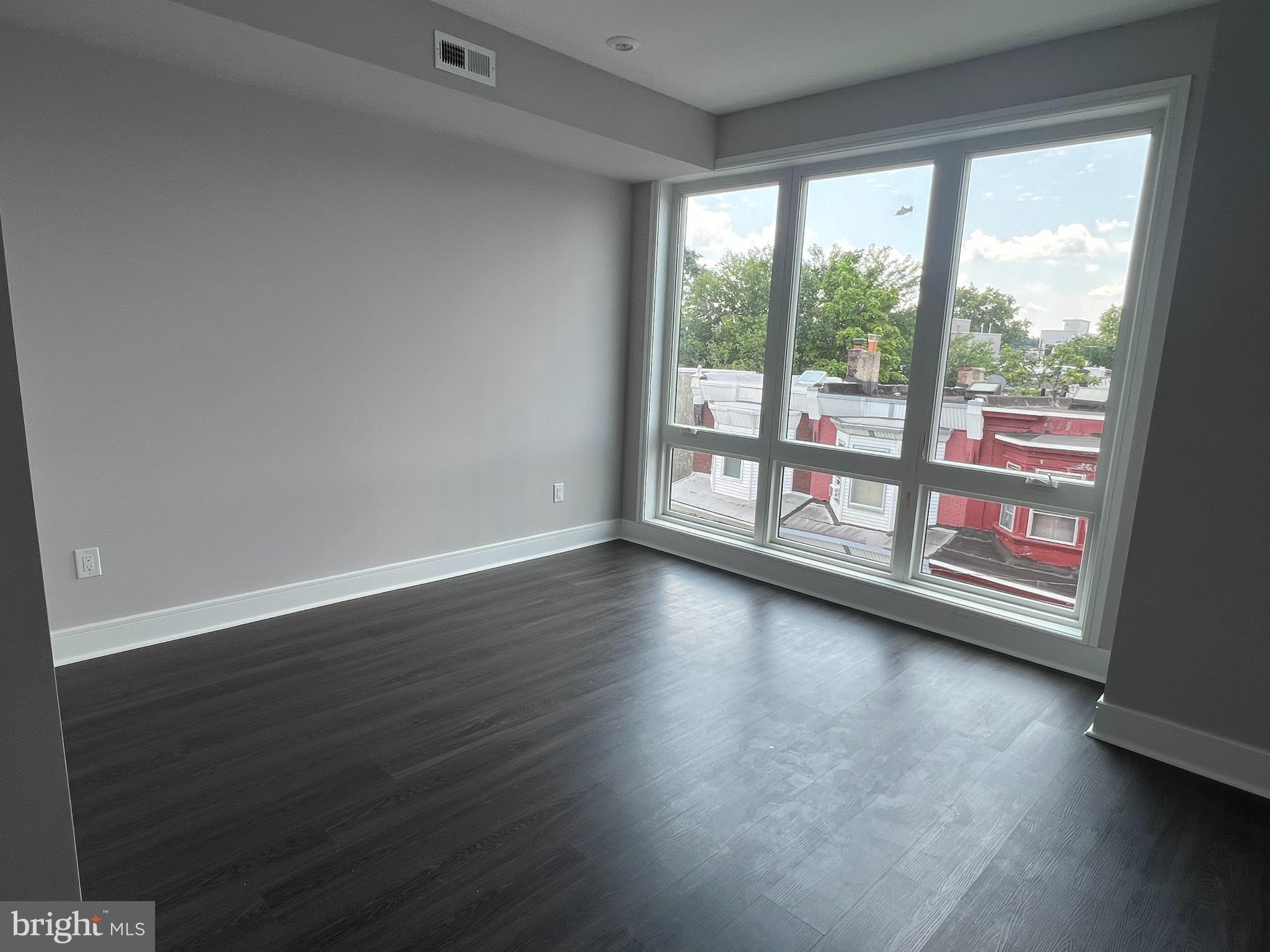 5239 Chancellor Street, Unit B Philadelphia, PA 19139 - Photo 12 of 18 a view of empty room with wooden floor and fan
