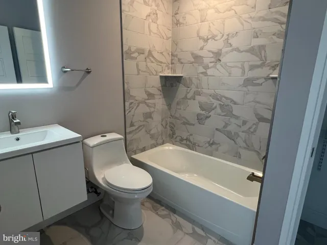 a bathroom with a toilet and a bathtub