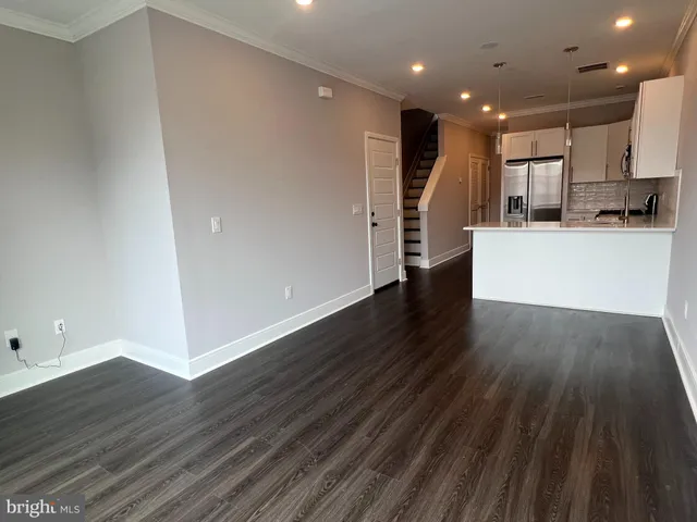 a view of kitchen with wooden floor and electronic appliances