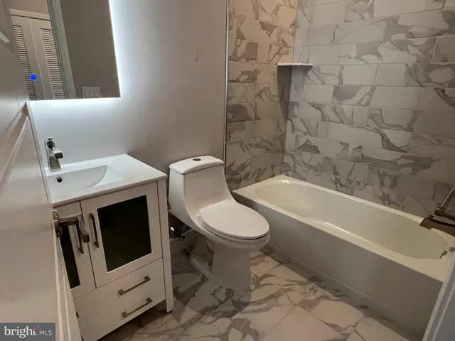 a bathroom with a toilet a sink and a bathtub