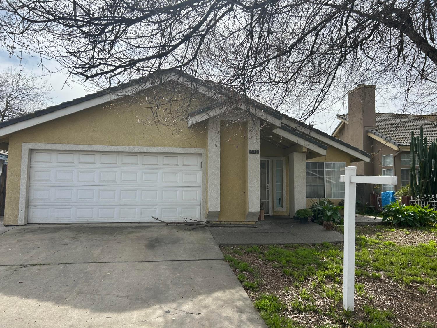 a front view of house with a garden