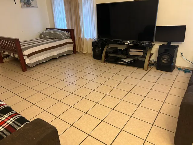 a bedroom with a bed and a flat screen tv