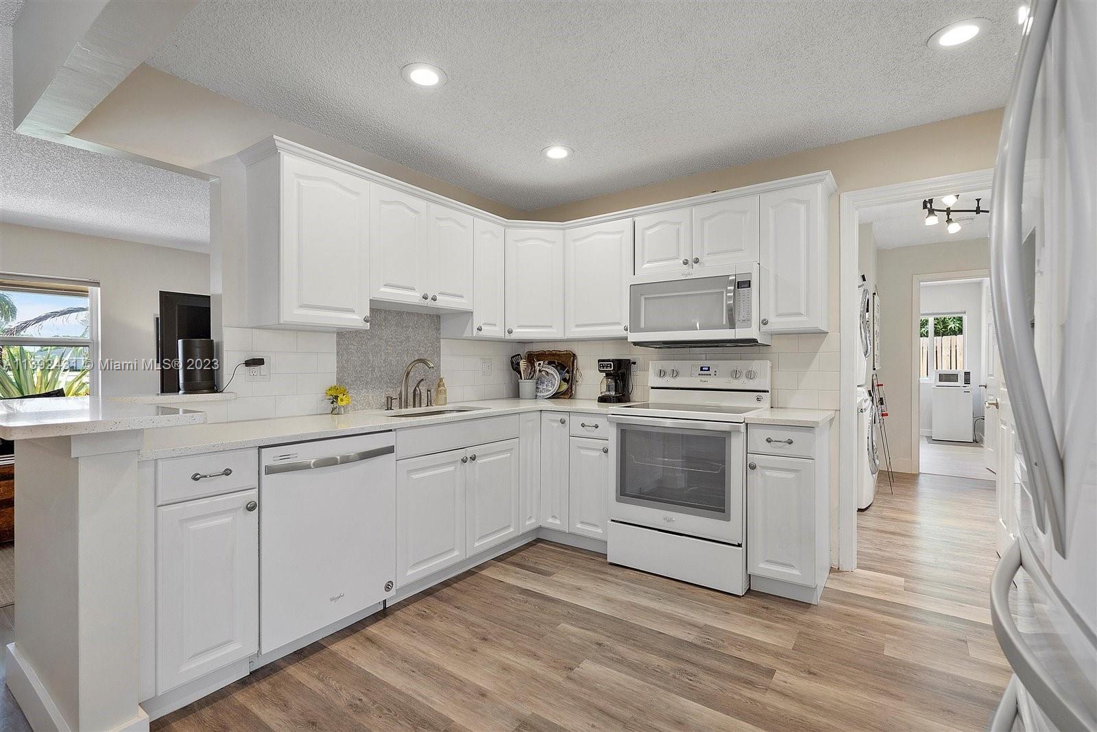 19404 Colorado Circle Boca Raton, FL 33434 - Photo 15 of 62 a kitchen with granite countertop white cabinets and white appliances