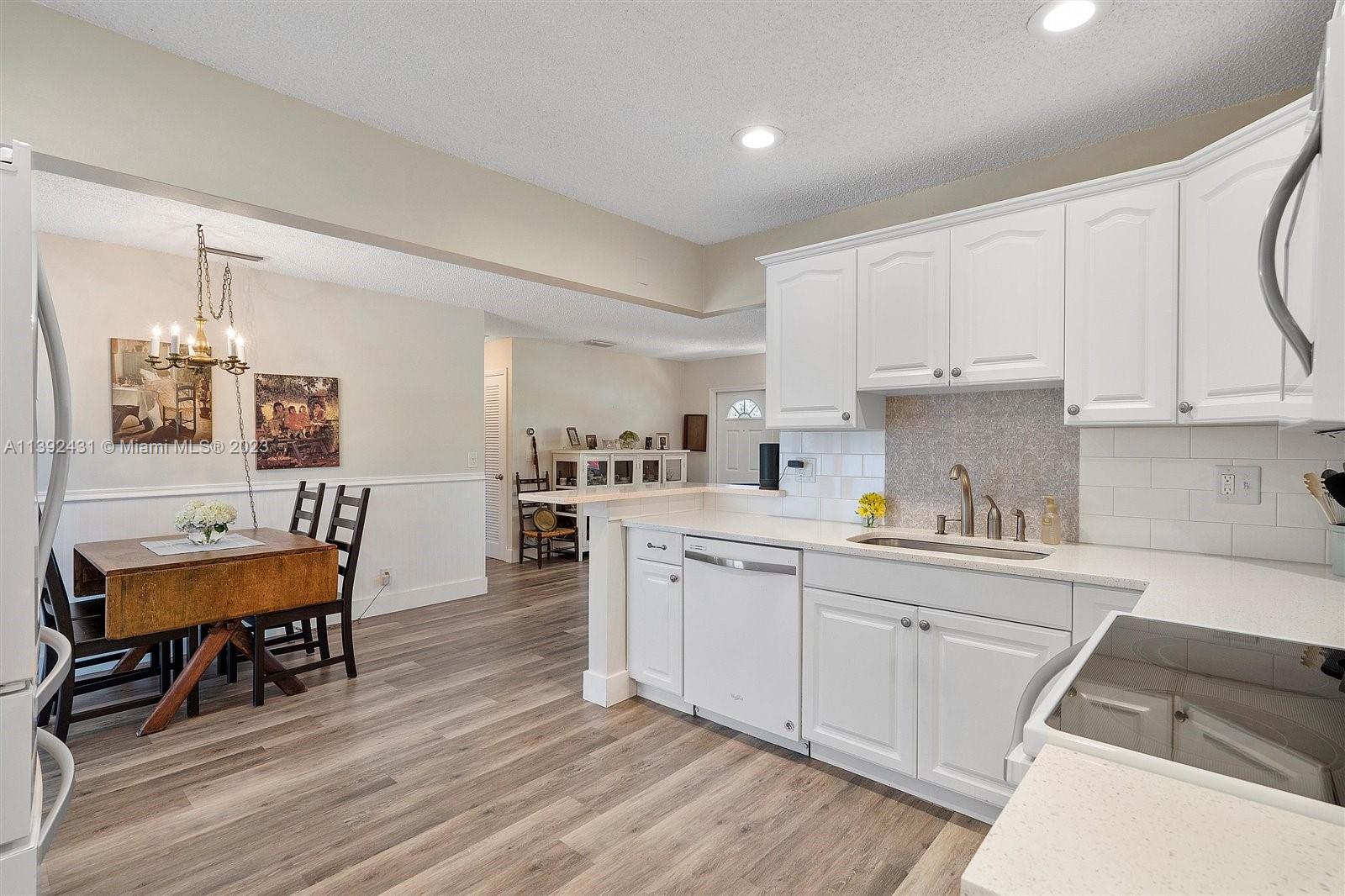 19404 Colorado Circle Boca Raton, FL 33434 - Photo 18 of 62 a kitchen with a sink cabinets and wooden floor