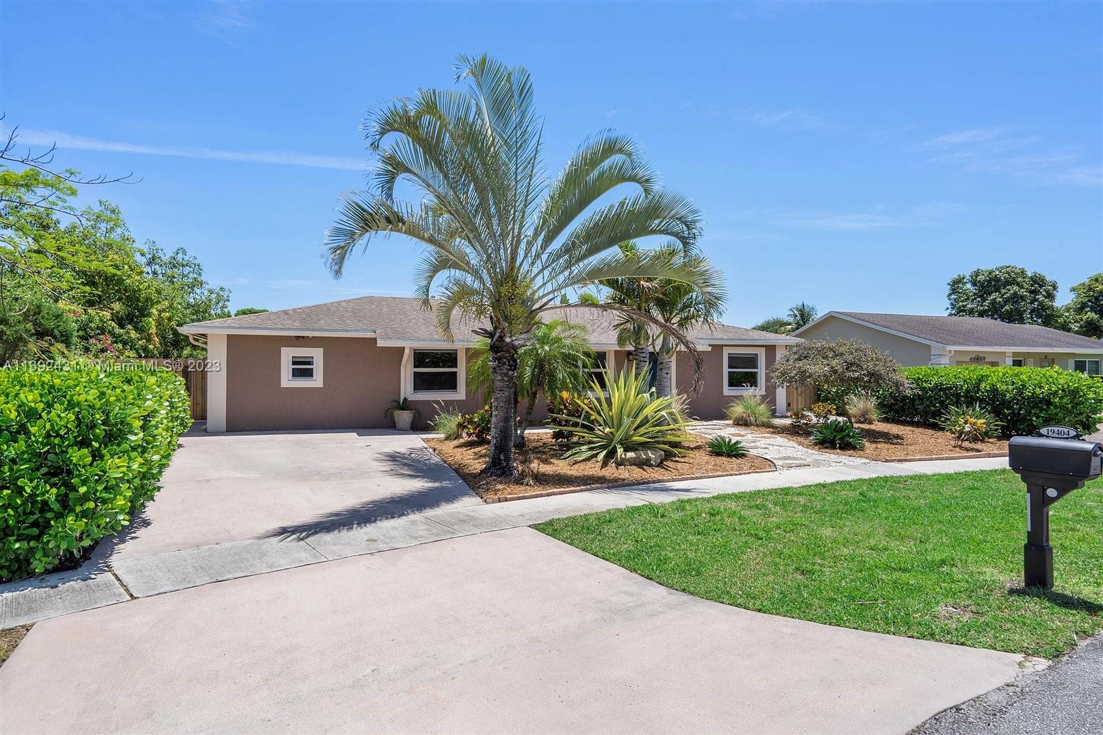 19404 Colorado Circle Boca Raton, FL 33434 - Photo 2 of 62 a front view of a house with a yard and porch