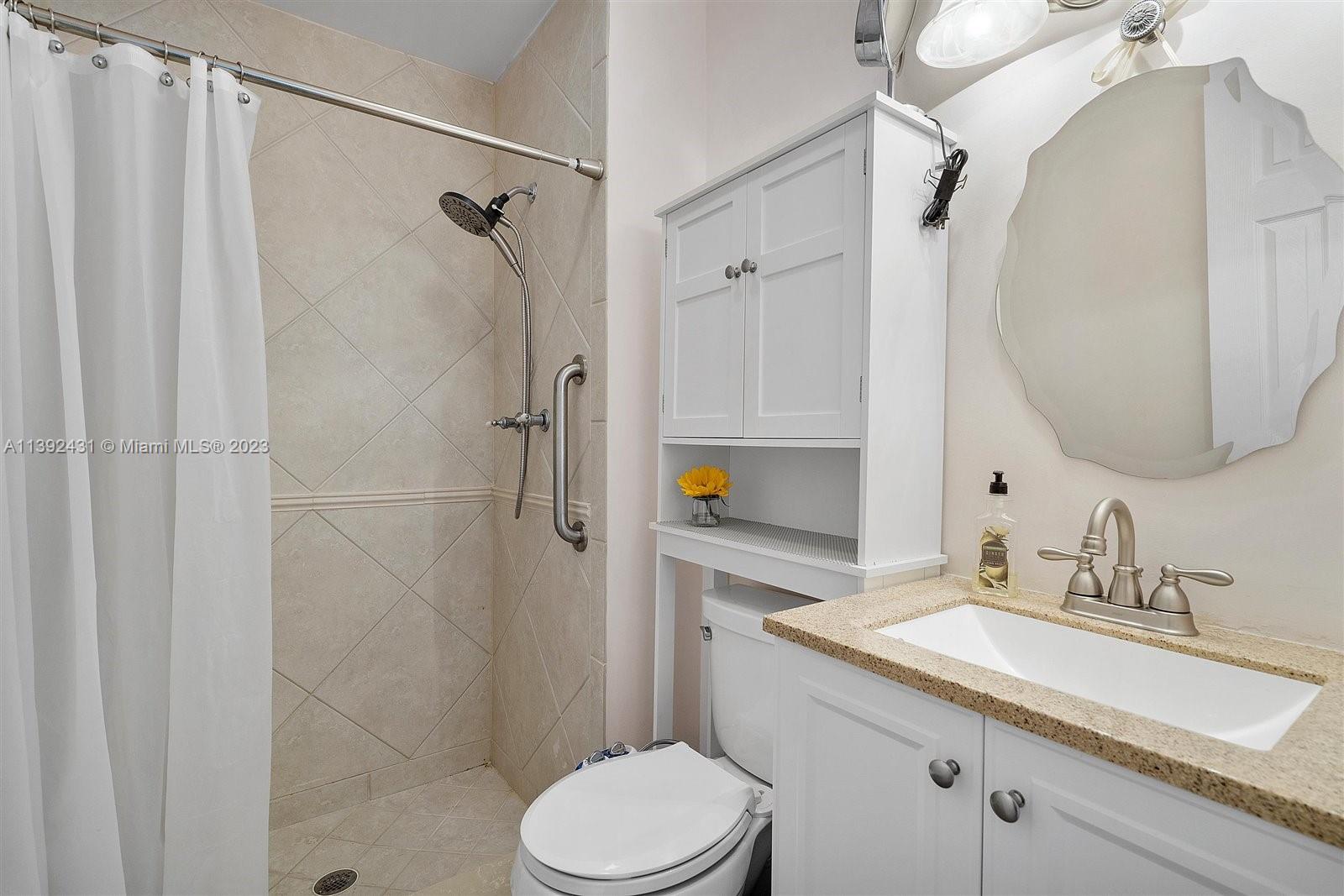 19404 Colorado Circle Boca Raton, FL 33434 - Photo 24 of 62 a bathroom with a sink toilet and shower