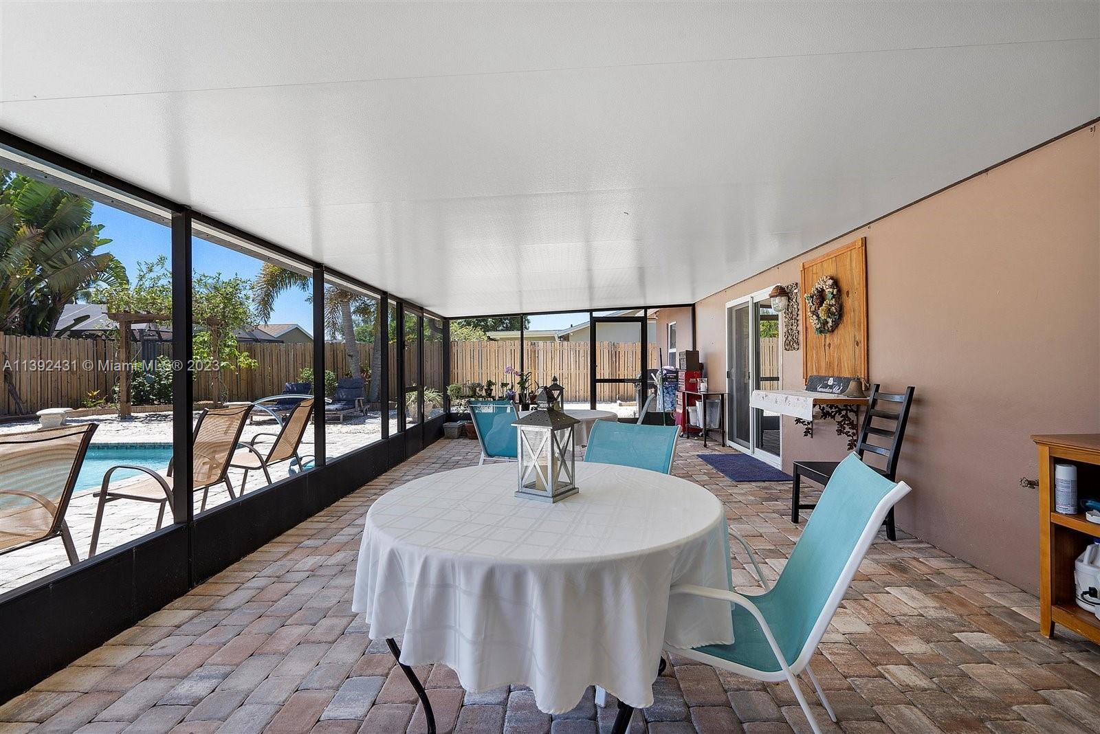 19404 Colorado Circle Boca Raton, FL 33434 - Photo 37 of 62 a dining room with furniture and a floor to ceiling window