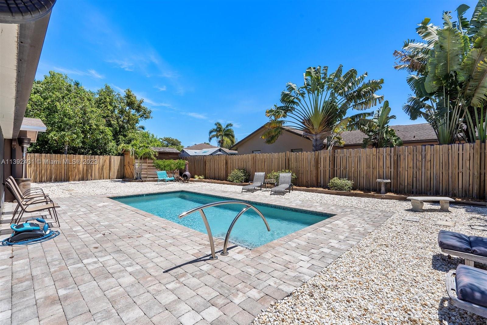 19404 Colorado Circle Boca Raton, FL 33434 - Photo 39 of 62 a view of a backyard with a table and chairs