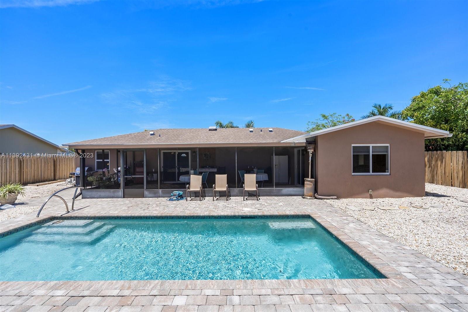 19404 Colorado Circle Boca Raton, FL 33434 - Photo 42 of 62 a front view of house with a garden and patio