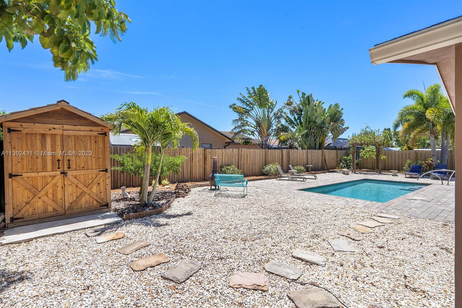 19404 Colorado Circle Boca Raton, FL 33434 - Photo 44 of 62 a view of a backyard with a tub and potted plants