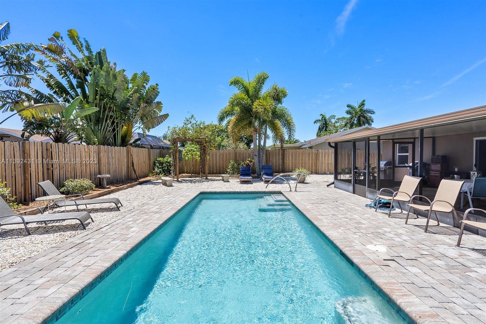 19404 Colorado Circle Boca Raton, FL 33434 - Photo 45 of 62 a view of swimming pool with lawn chairs and wooden fence