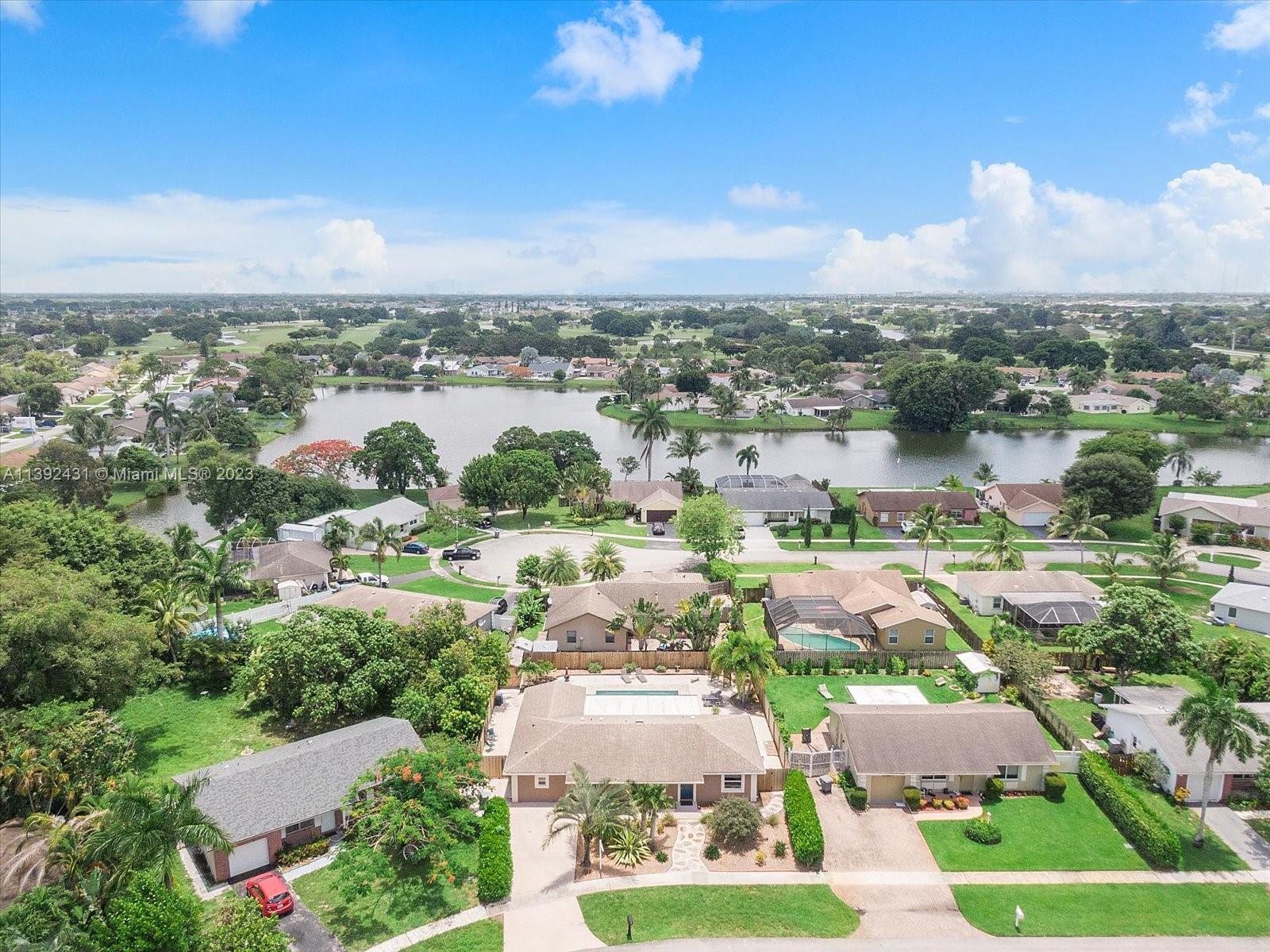19404 Colorado Circle Boca Raton, FL 33434 - Photo 50 of 62 an aerial view of a city with lots of residential buildings ocean and mountain view in back